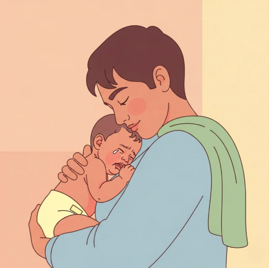 Parent holding a crying baby close with skin-to-skin contact